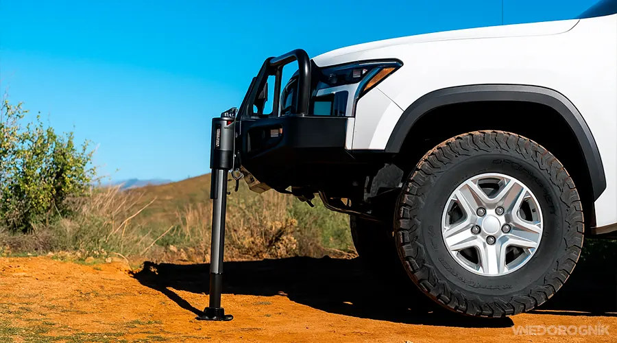 SUV being lifted with a reliable Hi-Lift jack.