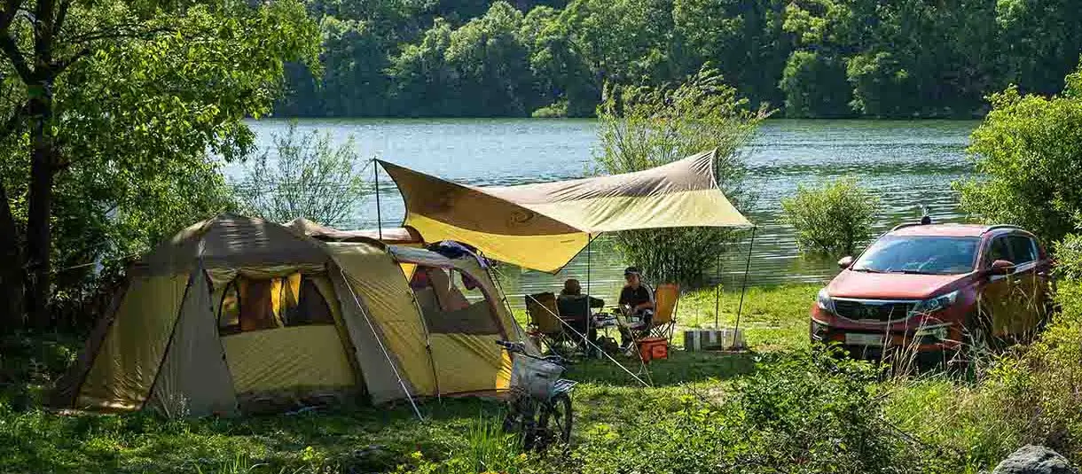 Tourist tent next to a car